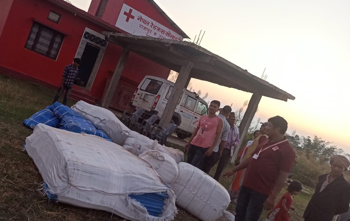 Nepal_RCS_3.jpg Preparing tarpaulins stocks for use as temporary shelters. © Nepal Red Cross Society